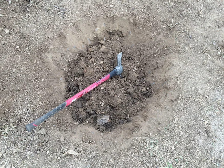 Using a Pick Axe to Break Up Tough Colorado Soil