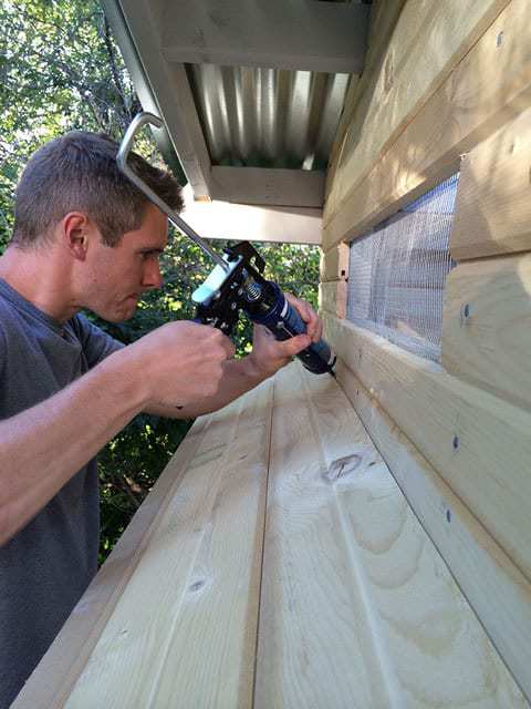 Applying waterproof caulk for nesting box