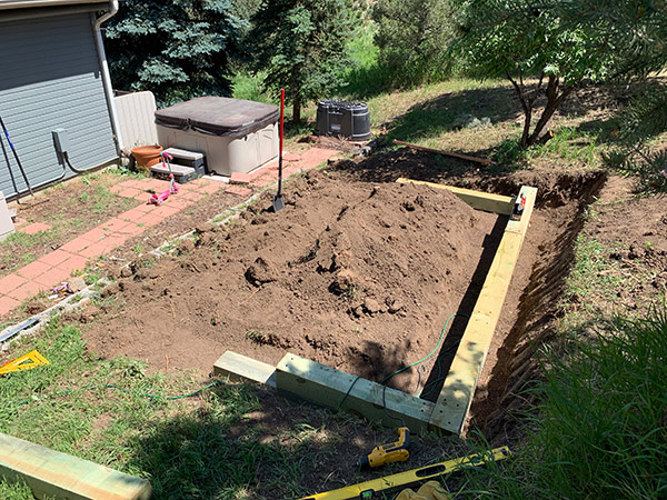 Level and Set Landscape Timbers for Retaining Wall 