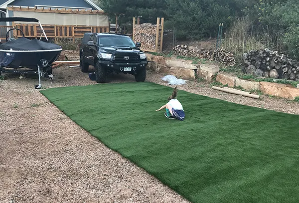 Laying out the artificial grass to cut and prep for landscape project.